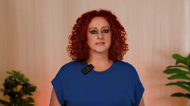 Presenter with red curly hair recording to camera